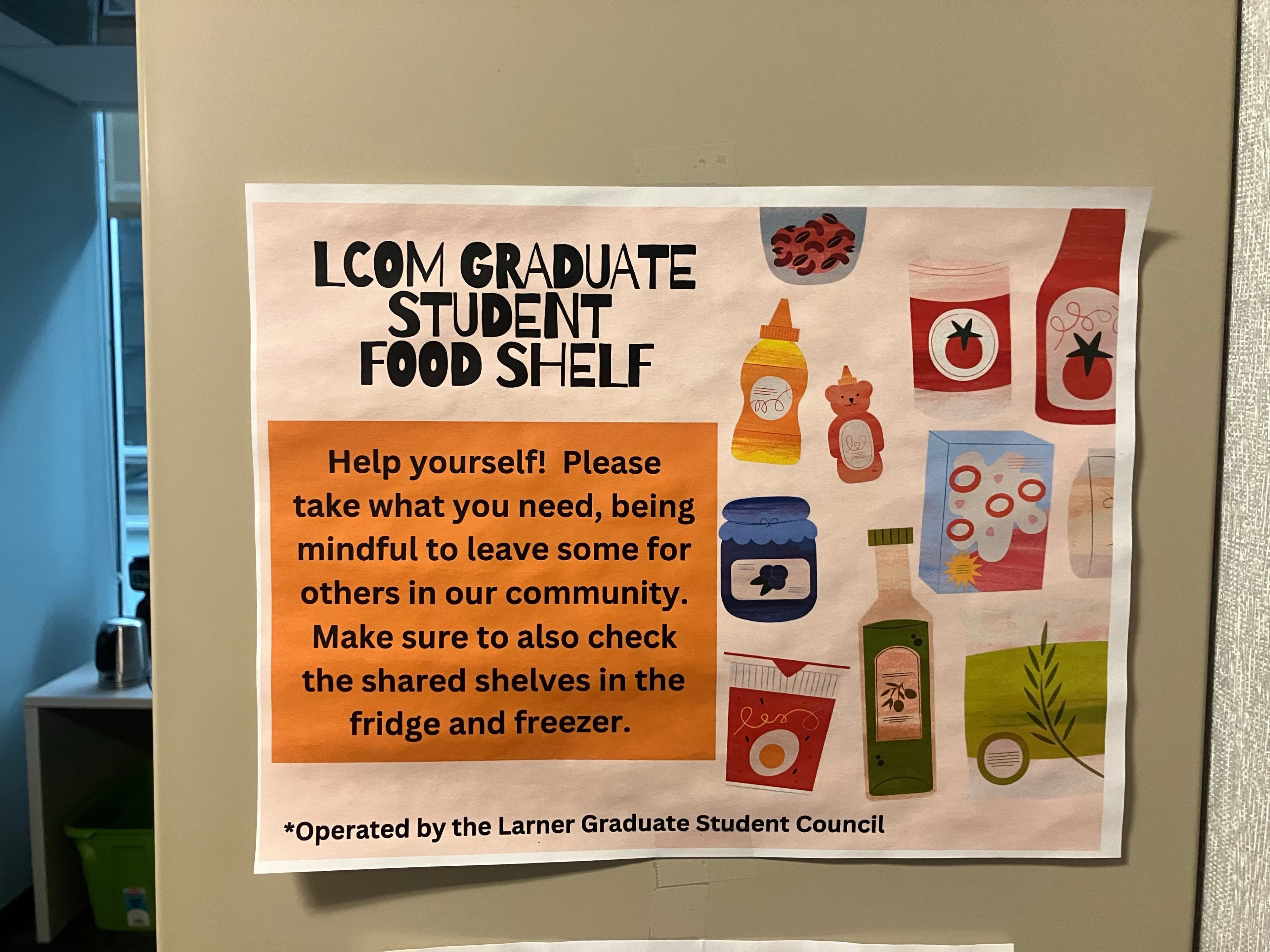 Sign reading: LCOM Graduate Student Food Shelf — Help yourself! Please take what you need, being mindful to leave some for others in our community. Operated by the Larner Graduate Student Council.